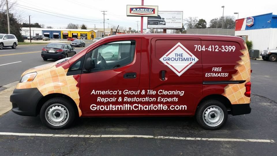 A red van is parked on the side of the road