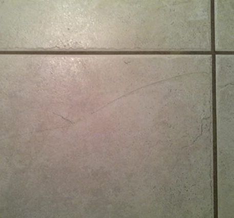 A close up of a tiled floor with a black border