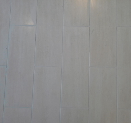 A close up of a white tile floor