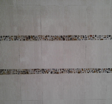A tiled wall with a leopard print border