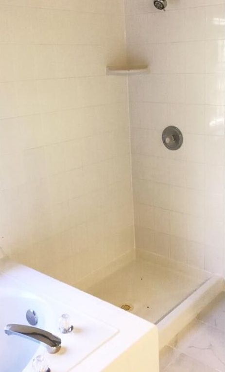 A bathroom with a bathtub and a walk in shower.
