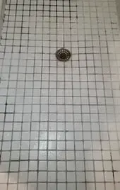 A bathtub in a bathroom with a shower head