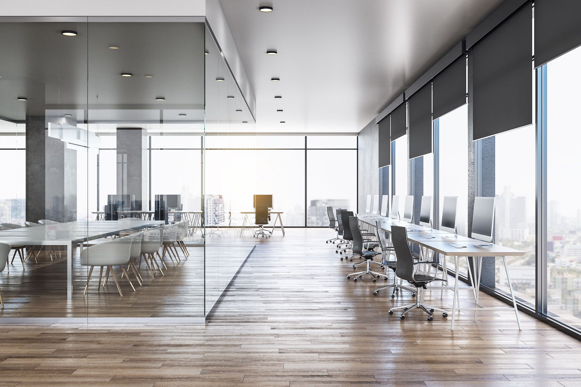 Modern office space with floor-to-ceiling windows, desks, chairs, and glass-walled conference room.