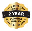 Gold warranty badge reading “Home of the 2 Year 24,000 Mile Warranty”