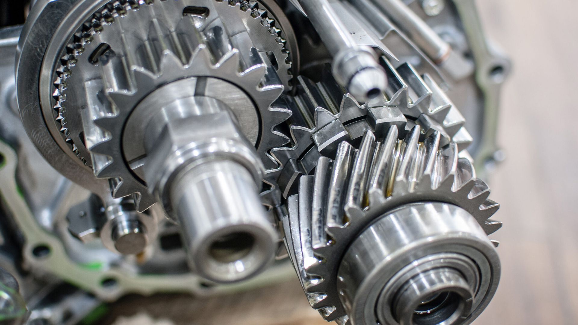 Close-up of shiny metal gears and cogs in a mechanical assembly
