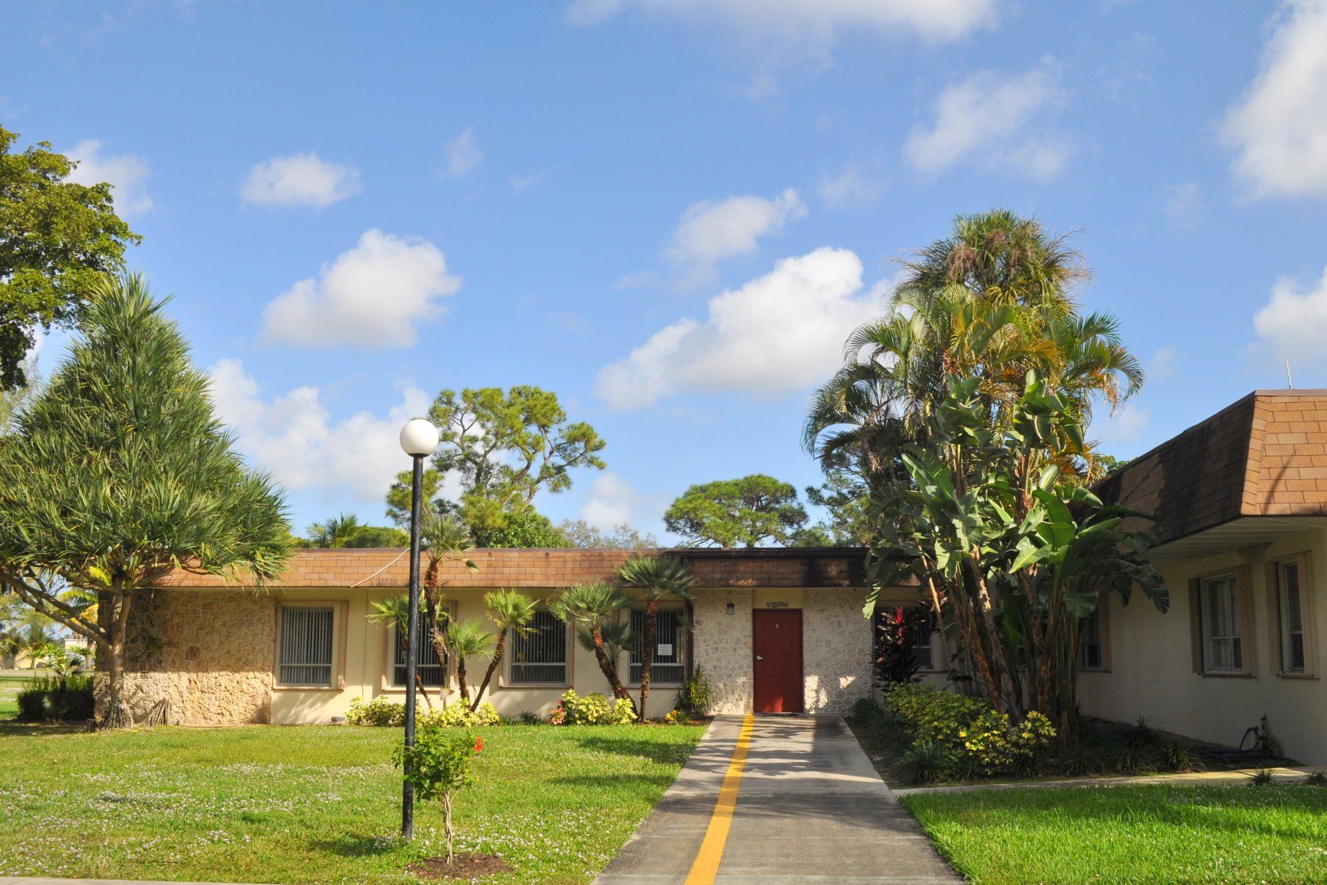 A house with a red door is next to another house
