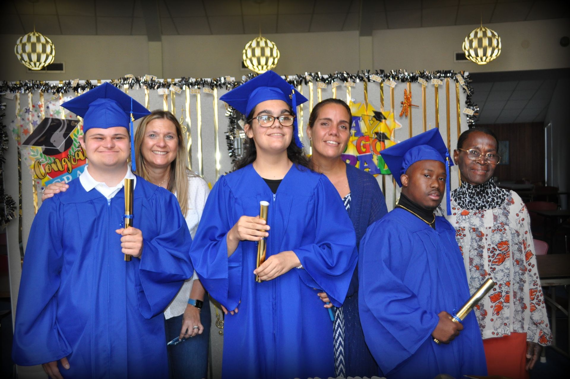 A group of graduates are posing for a picture