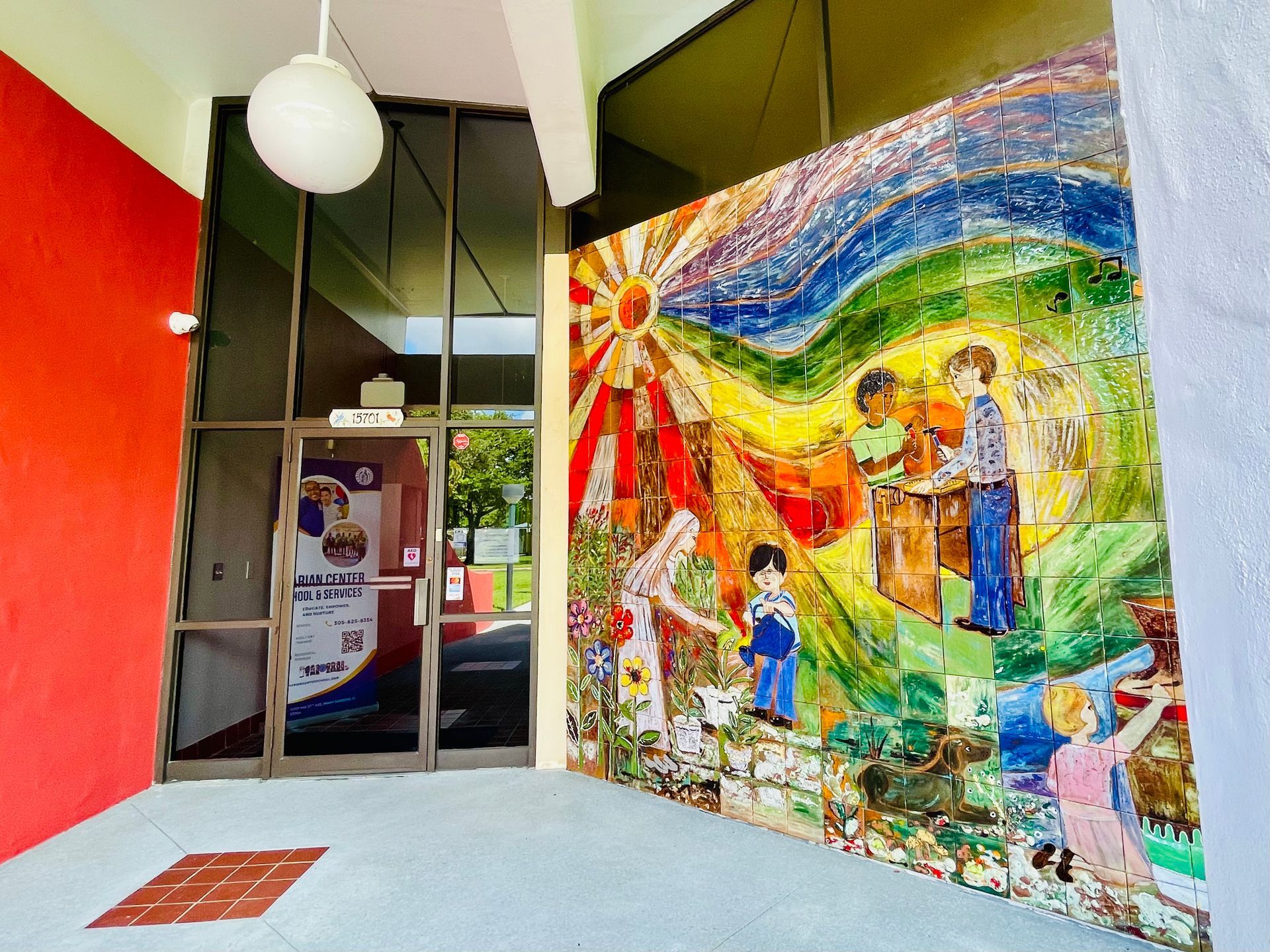 A group of people are sitting in a church with stained glass windows.