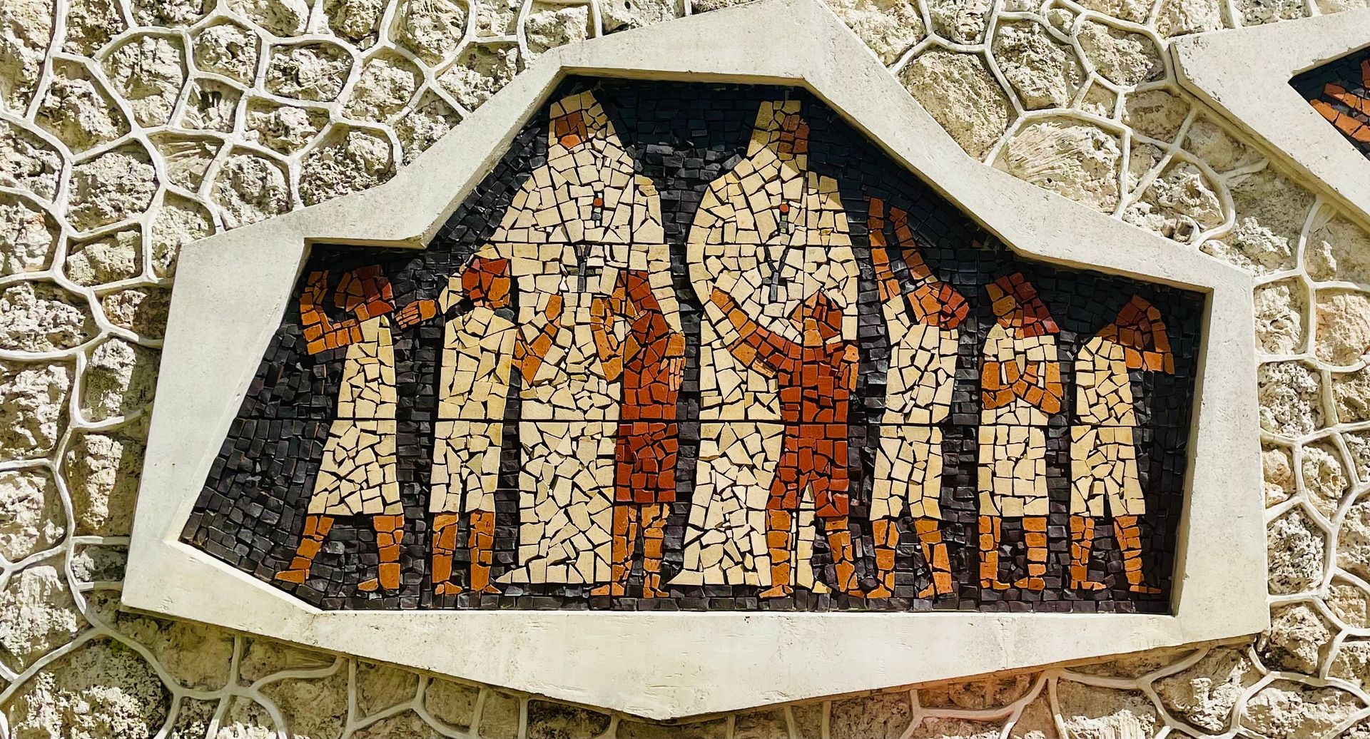 A large stone building with palm trees in front of it.