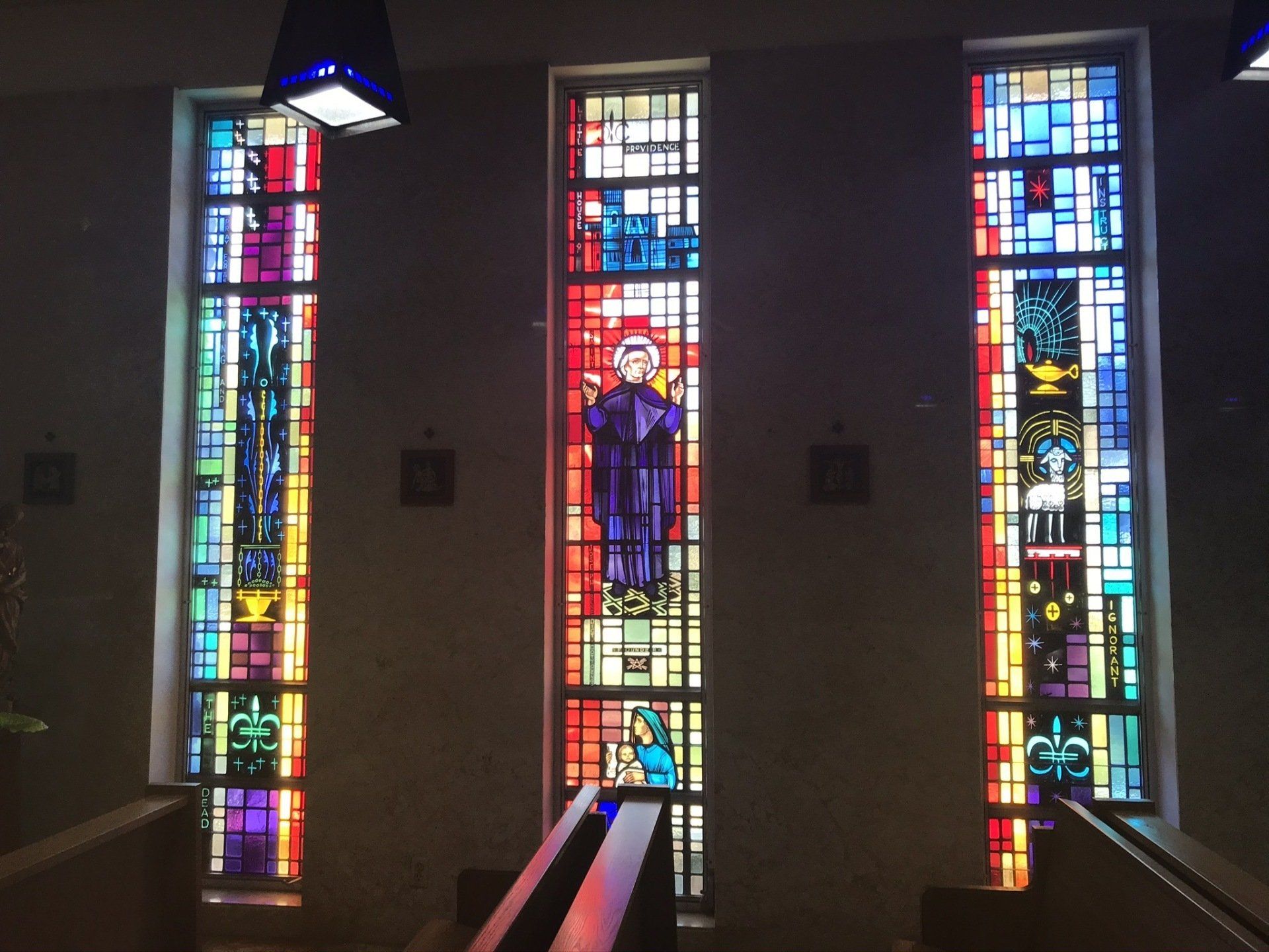 A stained glass window in a church with jesus on it