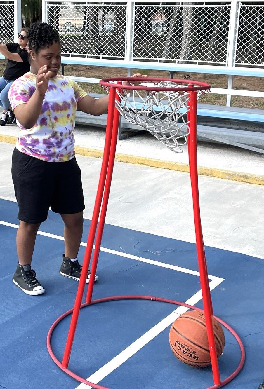 A young boy is playing basketball on a basketball court