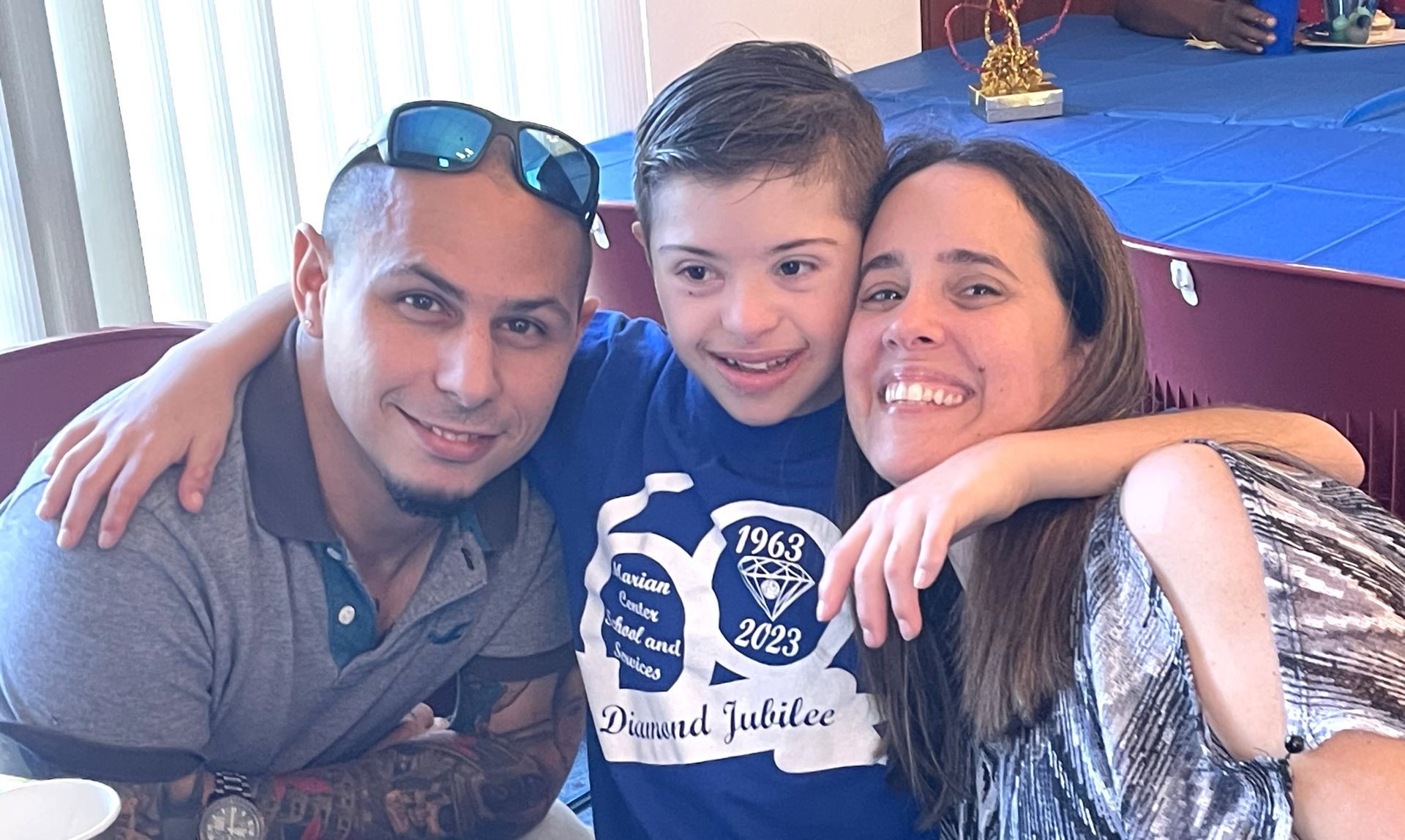 A man , a woman and a child are posing for a picture.