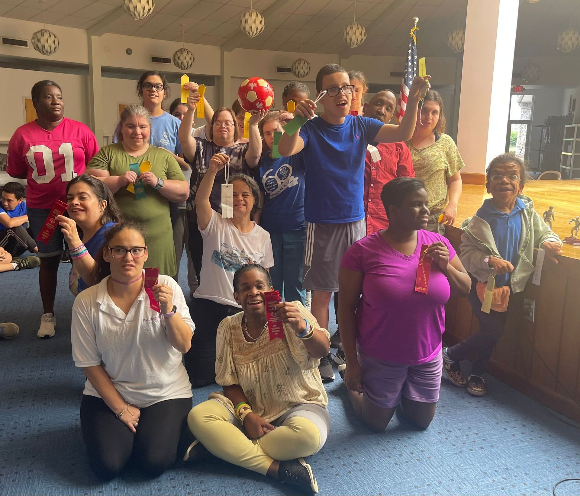 A group of people are posing for a picture in a room with pictures on the wall