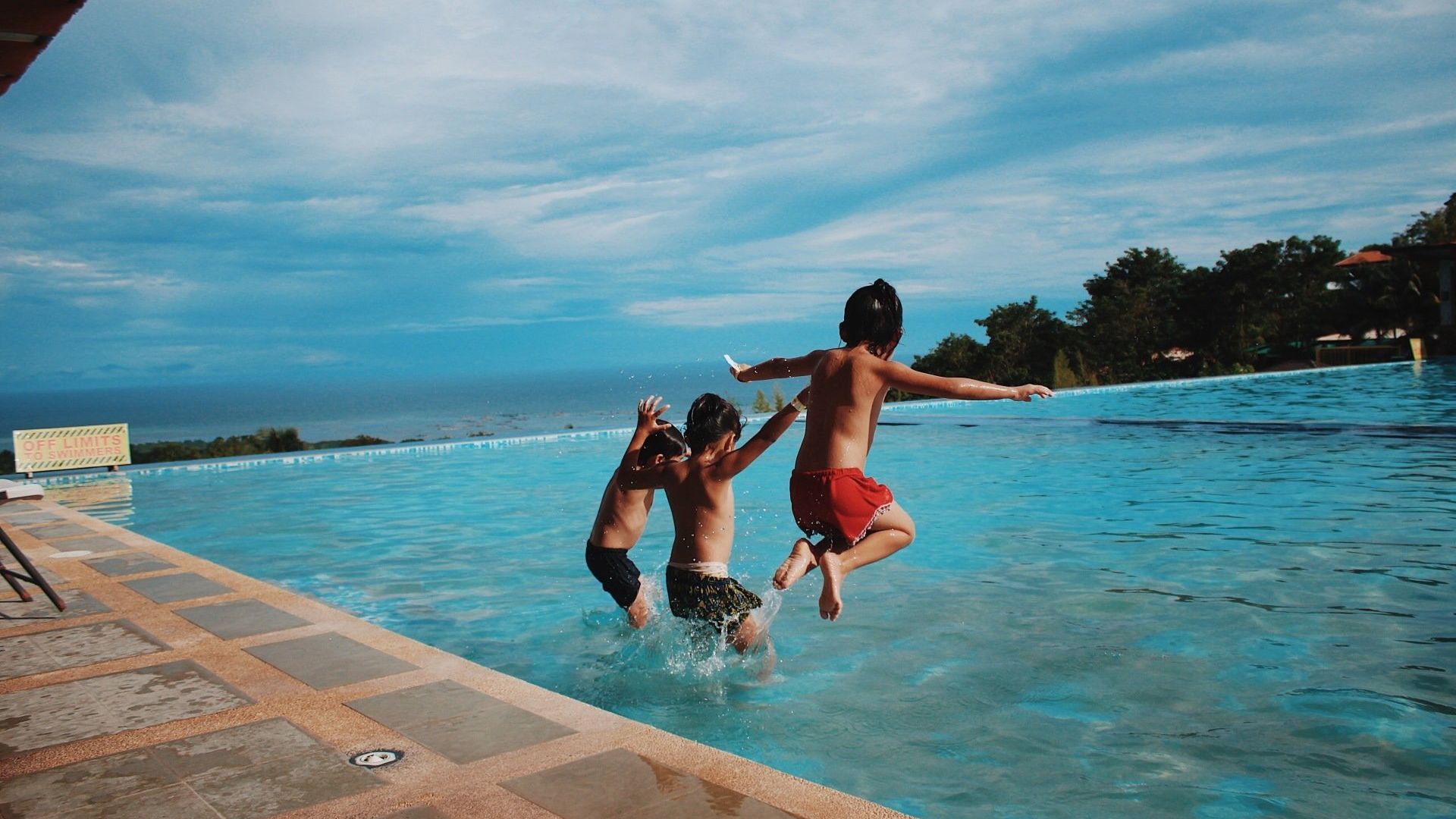 Kids jumping on the pool