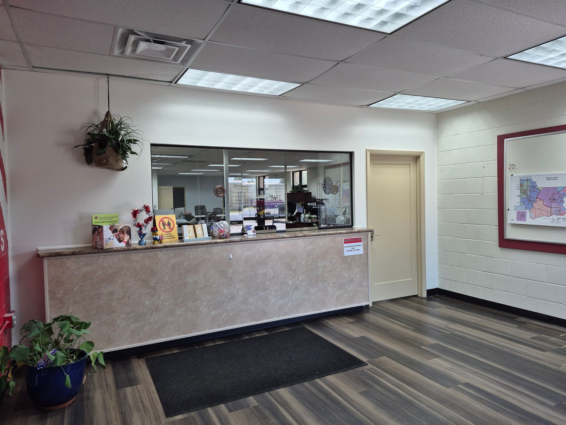 Reception area with a counter, a door, and a window.