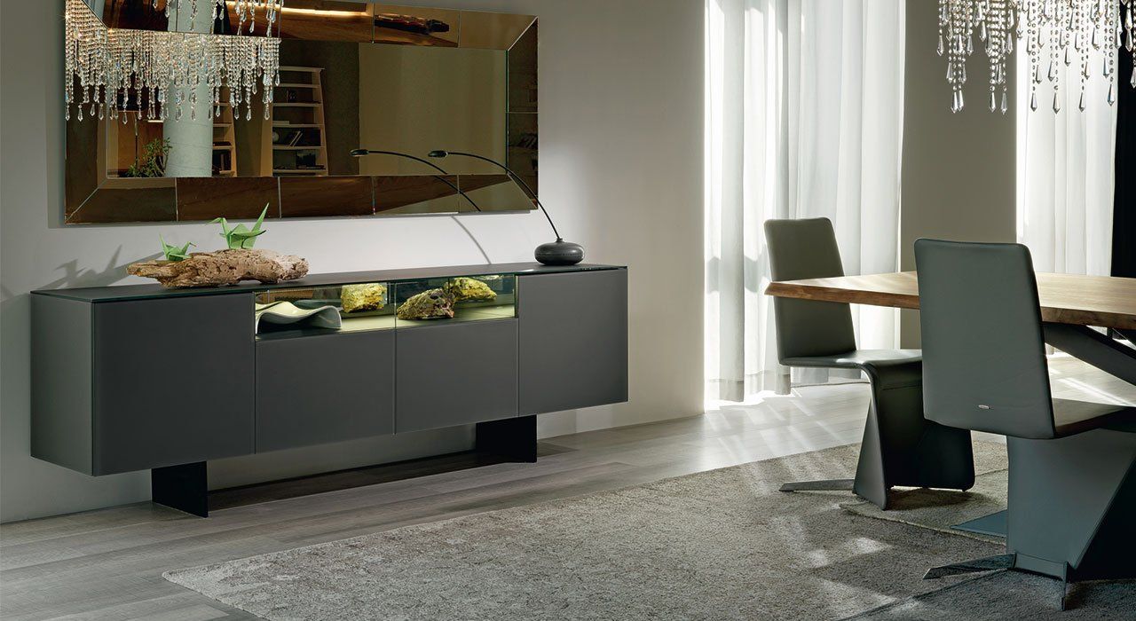 Cattelan Italia Continental Sideboard in Polished Graphite Glass with four doors and an LED lit open section and Graphite painted metal legs in a living room.