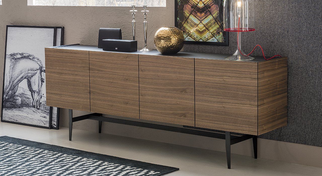 Cattelan Italia Dakota Sideboard with 3 or 4 doors, in Canaletto Walnut or Smoked Oak with extra clear translucent Mocha varnished Glass top. Graphite varnished wooden shelves inside and Graphite painted steel legs in a contemporary living dining room.