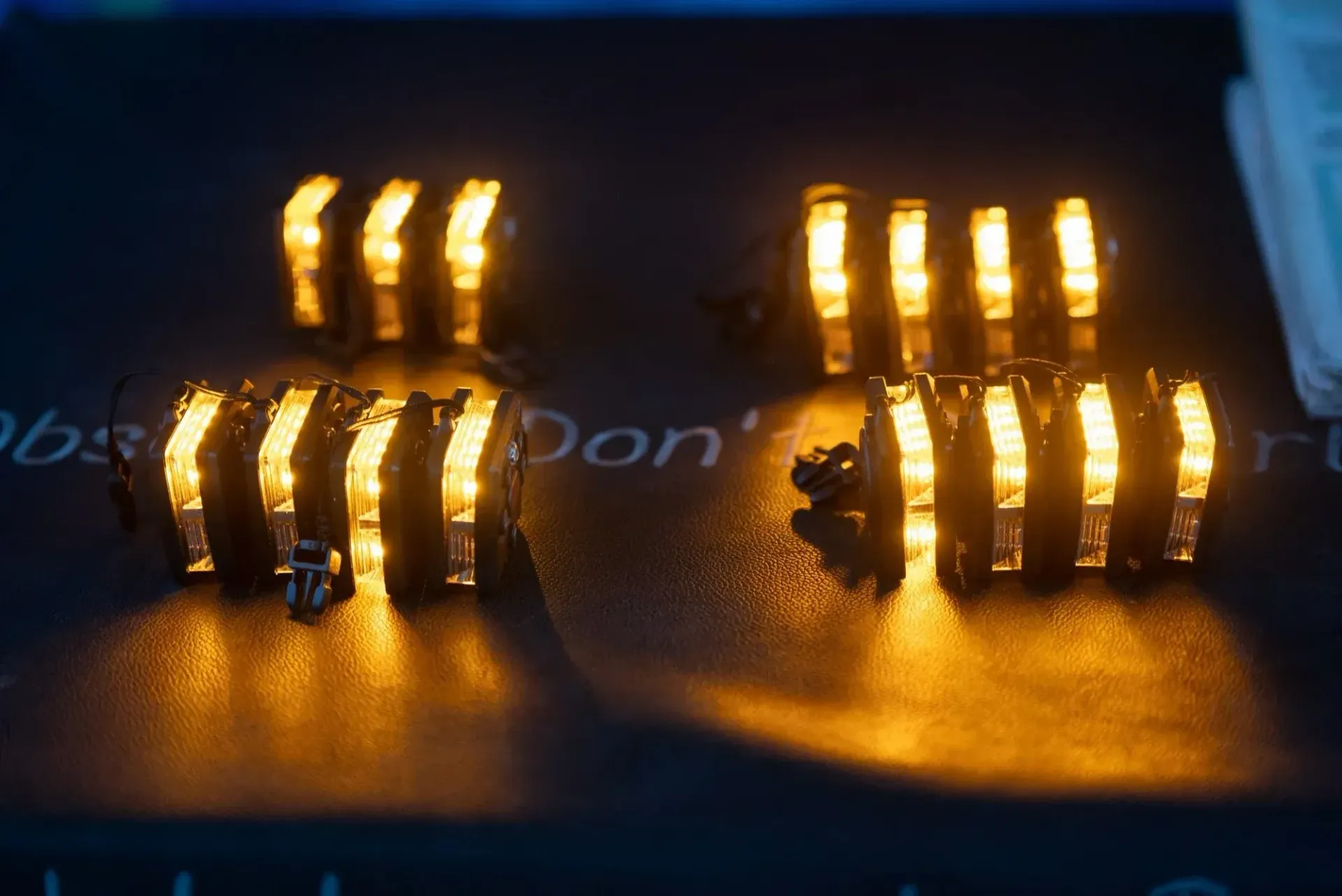 Glowing amber electronic components on a dark circuit board close-up