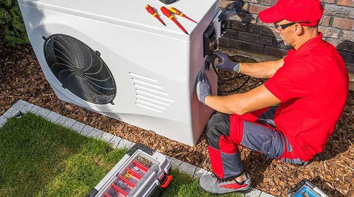 Technician Repairing Heat Pump Unit

