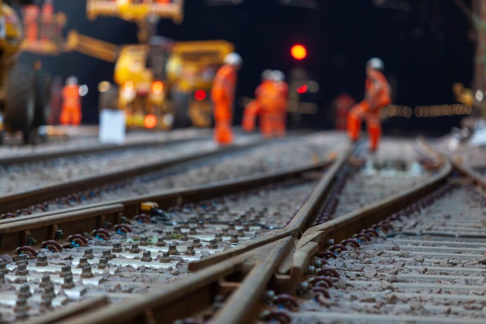 A group of construction workers are working on train tracks β LJ's Technical Services In Burdell, QLD