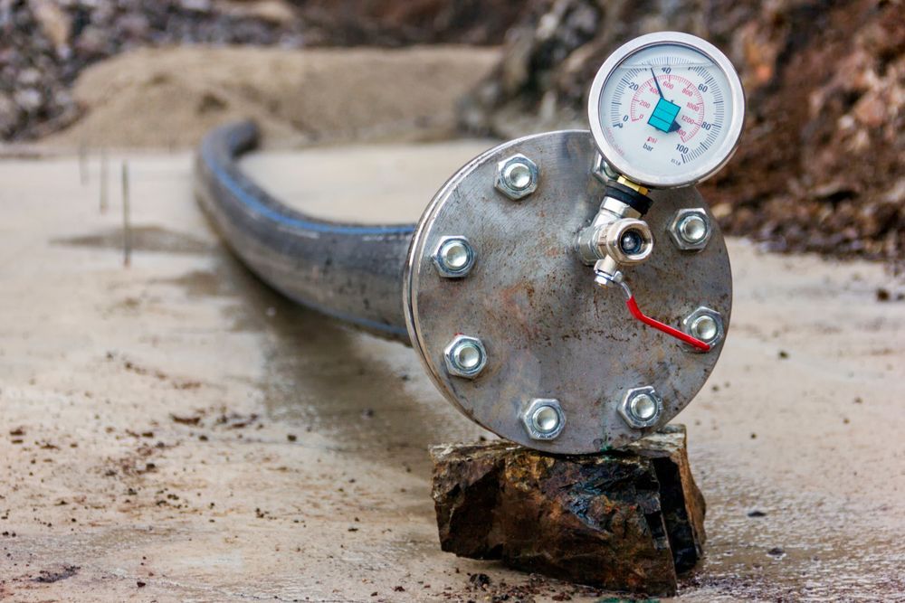 A Metal Pipe With A Pressure Gauge — LJ's Technical Services In Burdell, QLD