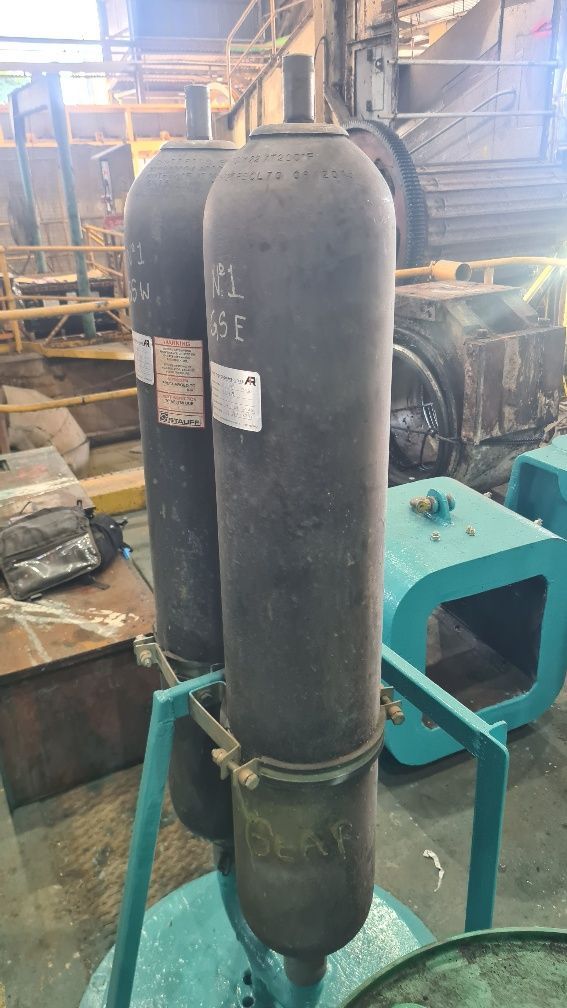 A Couple Of Cylinders Sitting On Top Of A Table In A Factory — LJ's Technical Services In Burdell, QLD
