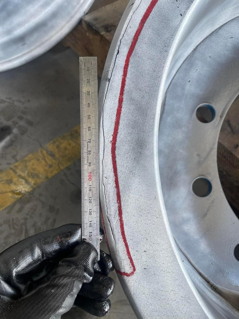 A Person Is Measuring A Wheel With A Ruler — LJ's Technical Services In Burdell, QLD