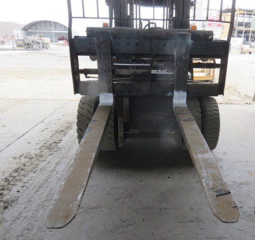 A Forklift Is Parked In A Garage With Its Forks Extended — LJ's Technical Services In Burdell, QLD