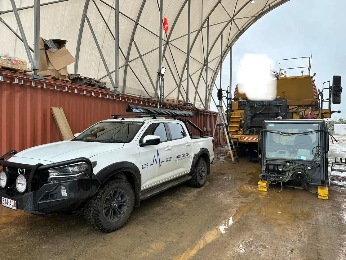 A White Truck Is Parked In Front Of A Large Building — LJ's Technical Services In Hunter Valley, NSW
