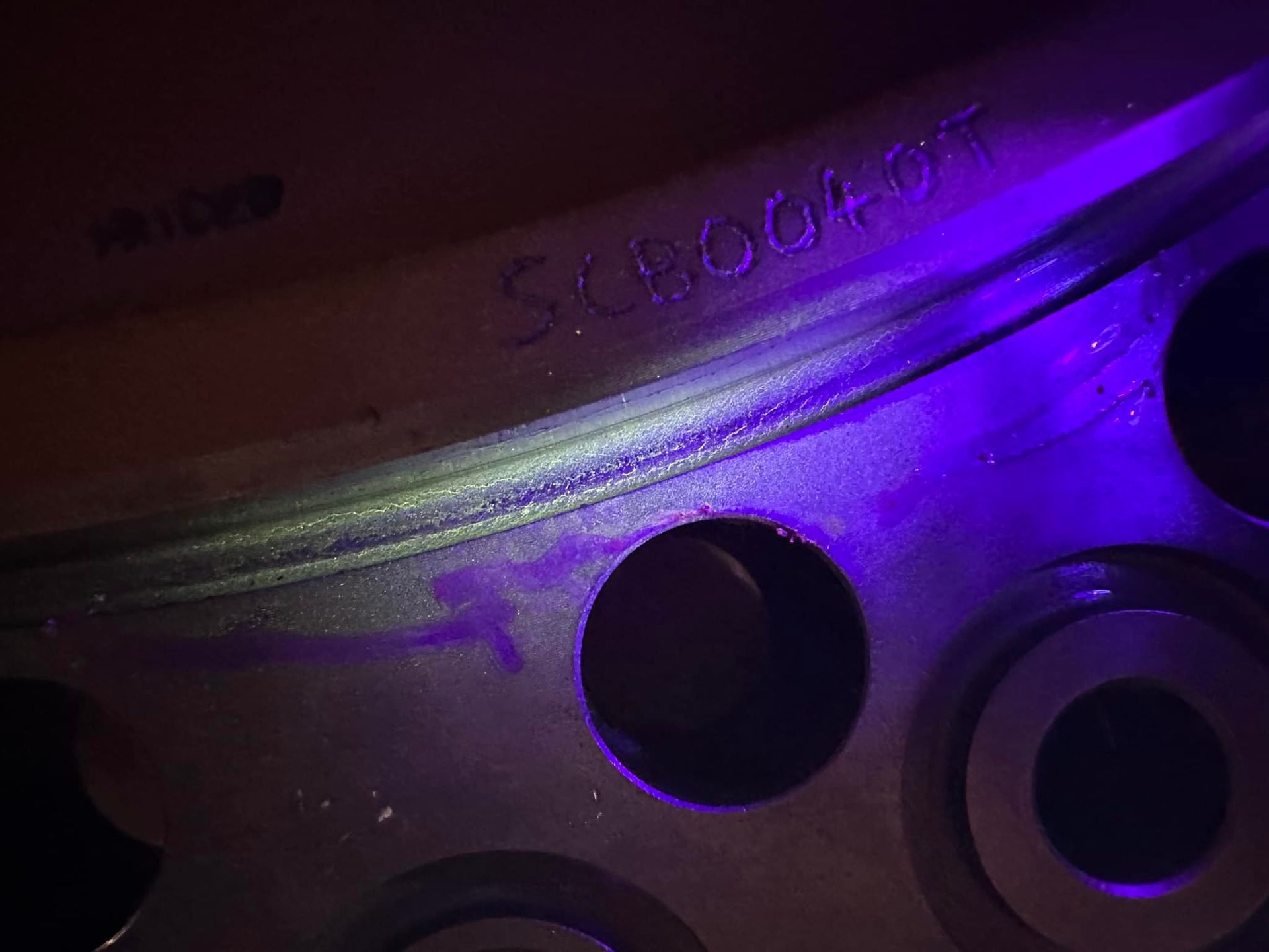 A Close Up Of A Metal Object With A Purple Light Shining On It — LJ's Technical Services In Burdell, QLD