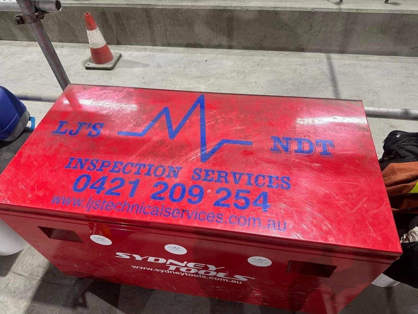 A Red Box That Says Inspection Services On It — LJ's Technical Services In Burdell, QLD