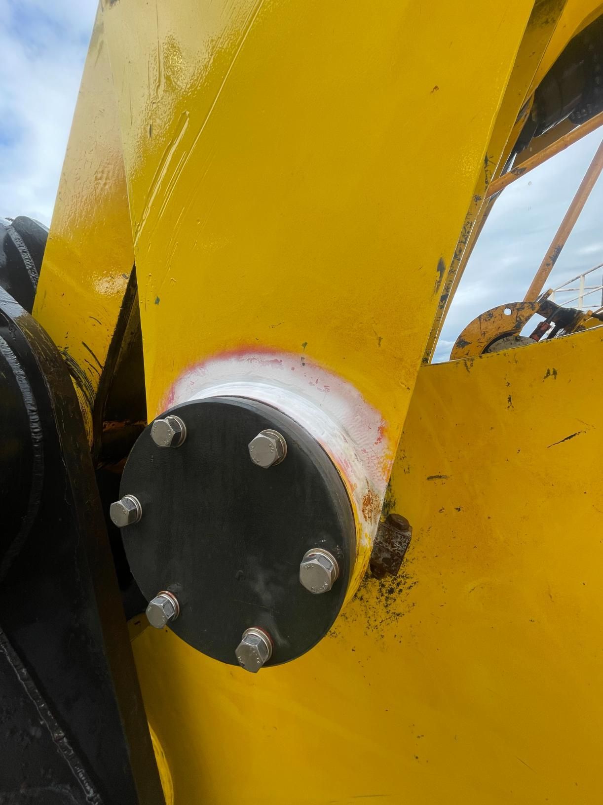 A Close Up Of A Yellow Object With A Black Circle On It — LJ's Technical Services In Burdell, QLD