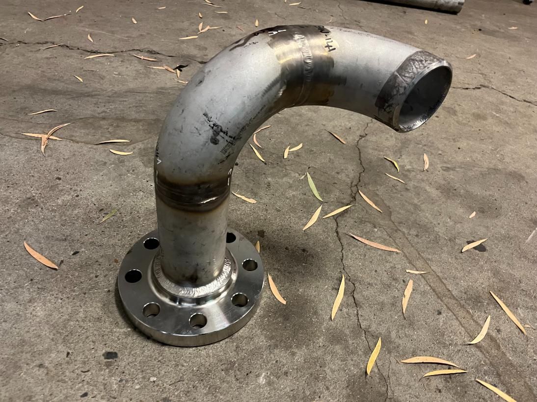 A Metal Pipe With A Flange On It Is Sitting On The Ground — LJ's Technical Services In Burdell, QLD