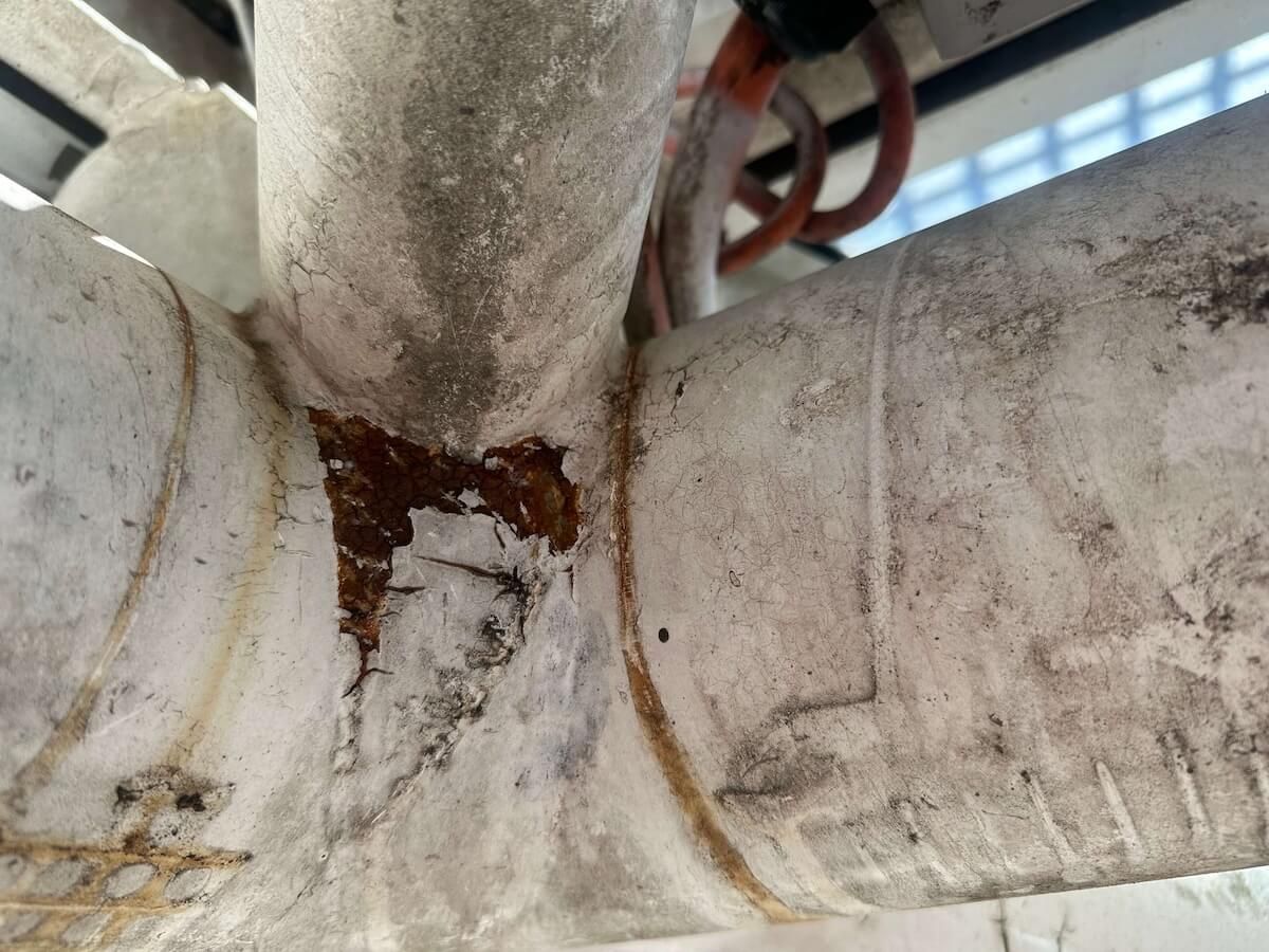 A close up of an old rusty pipe with corrosion — LJ's Technical Services In Burdell, QLD