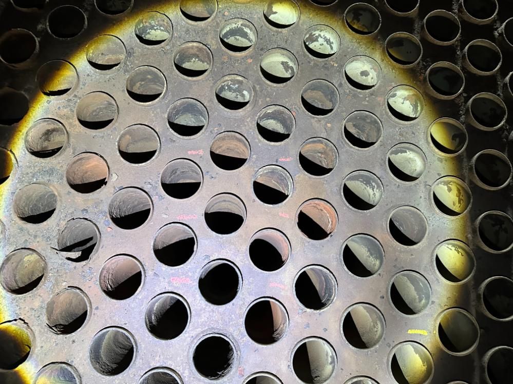 A Close Up Of A Metal Surface With Holes In It — LJ's Technical Services In Burdell, QLD