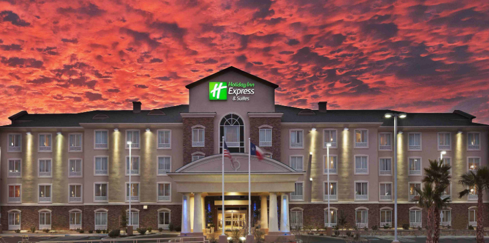 Holiday Inn Express & Suites with a dramatic red sky backdrop.