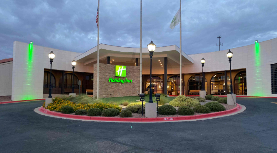 Holiday Inn entrance with landscaping and exterior lighting.