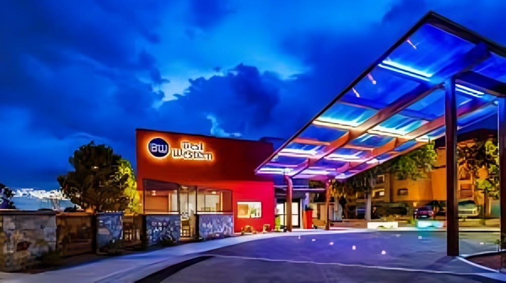 Best Western hotel entrance at night with blue canopy lights.
