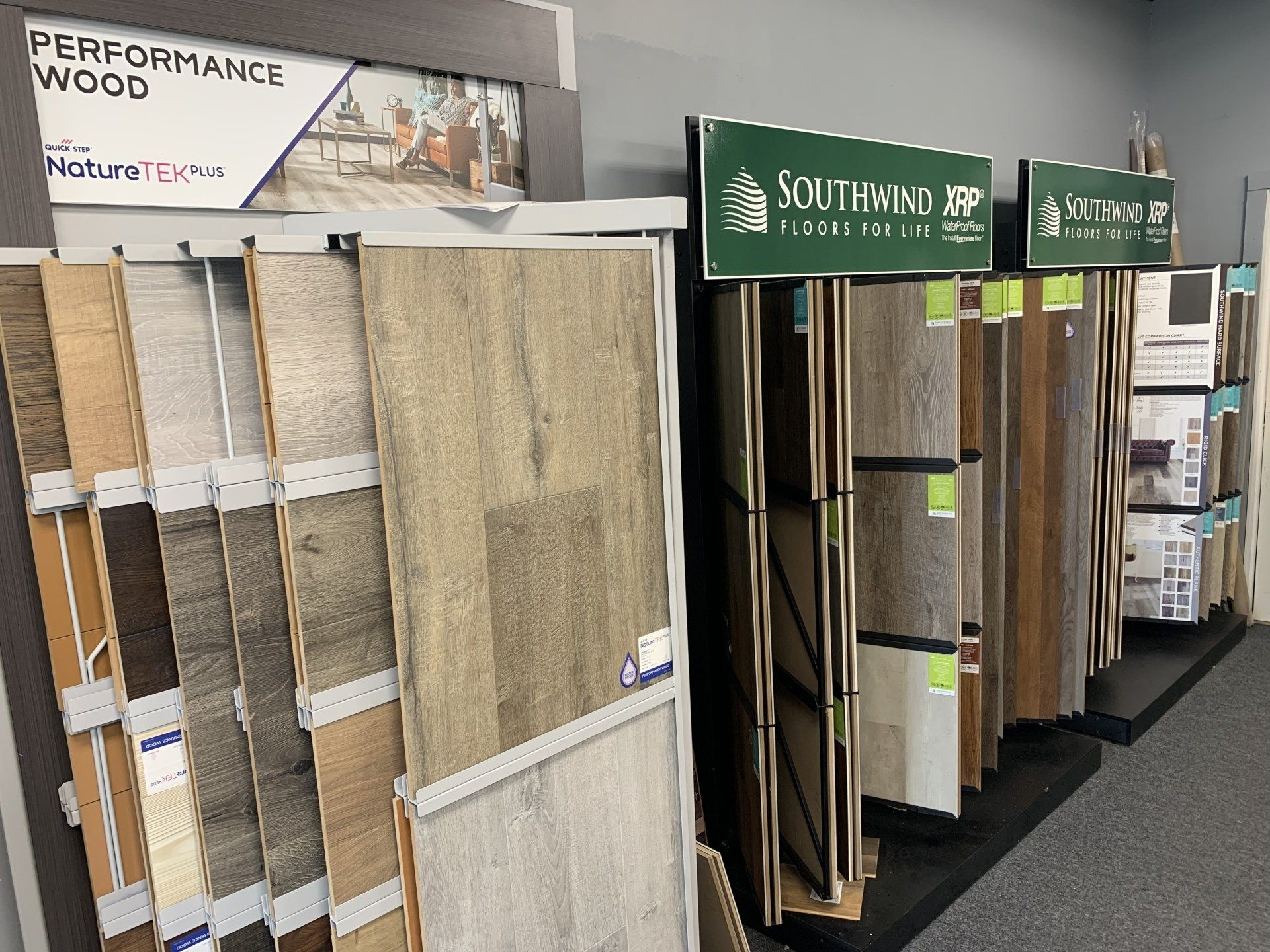 A display of different types of wood flooring in a store.