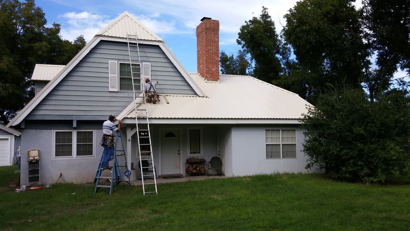 Two Men Doing Roof Repairs — ENM Construction Management Ltd