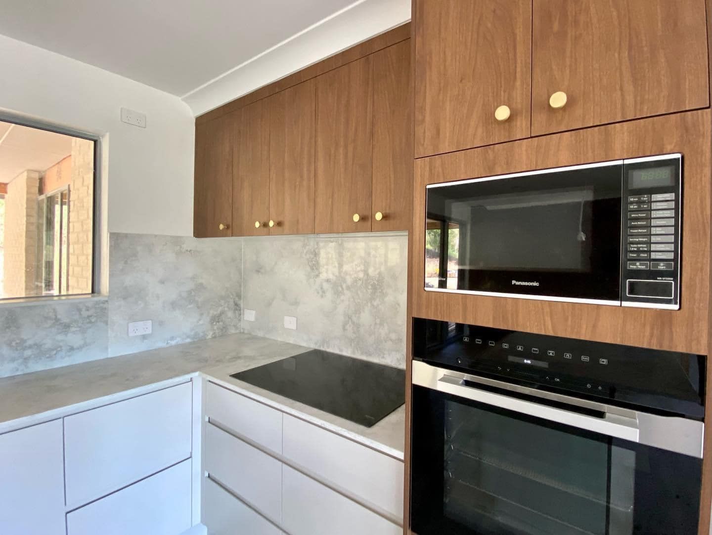 A Kitchen With Wooden Cabinets , A Stove Top Oven , And A Microwave — O'Donnell Cabinetmaking in Kawana, QLD