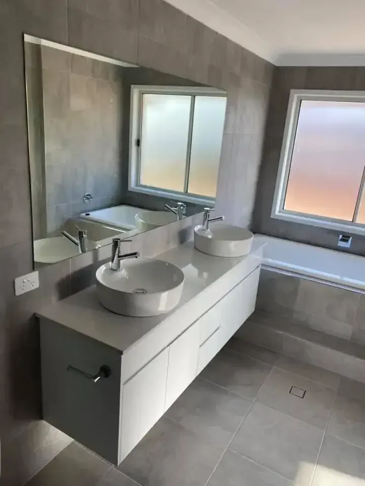 A Bathroom With Two Sinks , A Bathtub And A Large Mirror — O'Donnell Cabinetmaking in Kawana, QLD