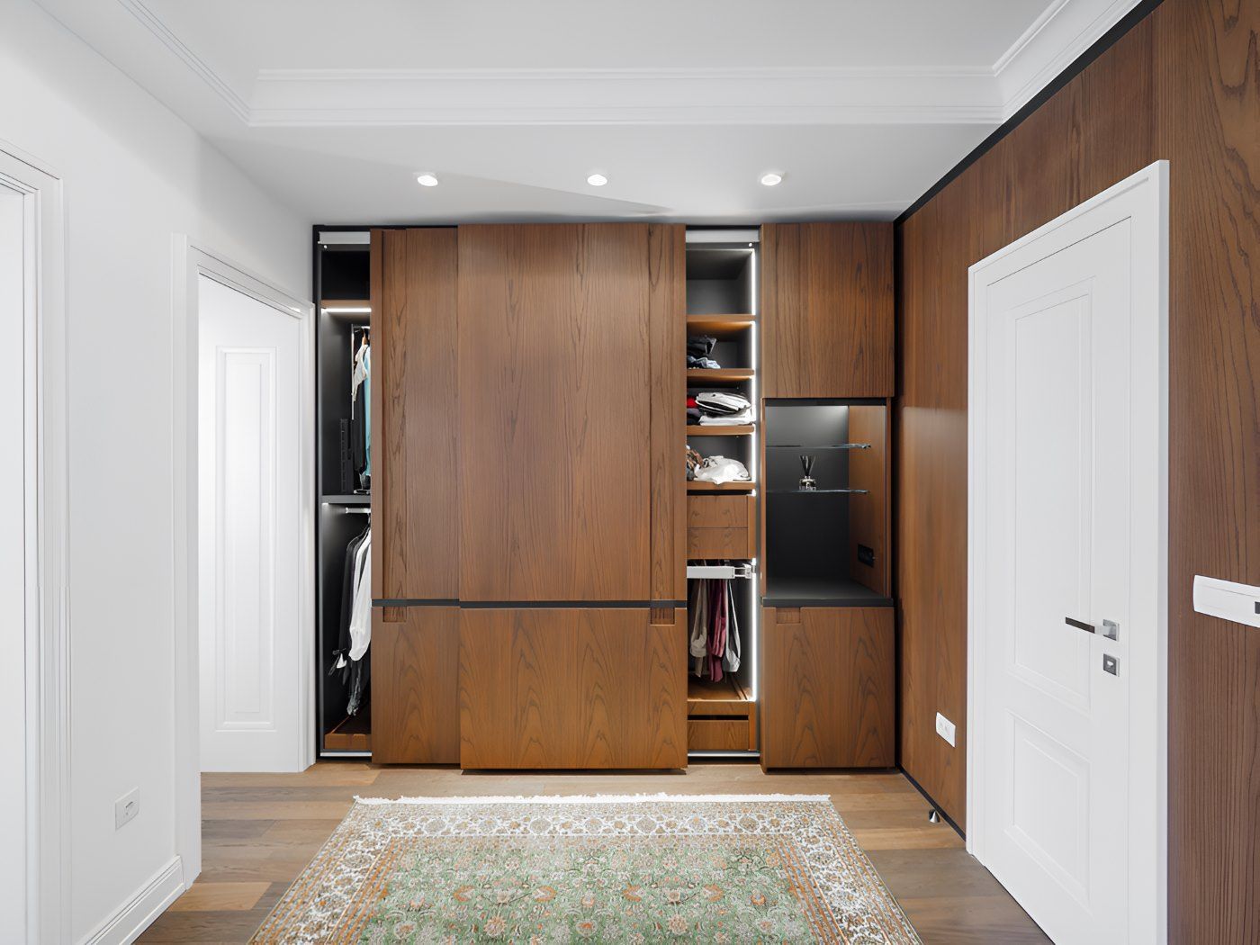 A Walk In Closet With Sliding Wooden Doors And A Rug — O'Donnell Cabinetmaking in Kawana, QLD