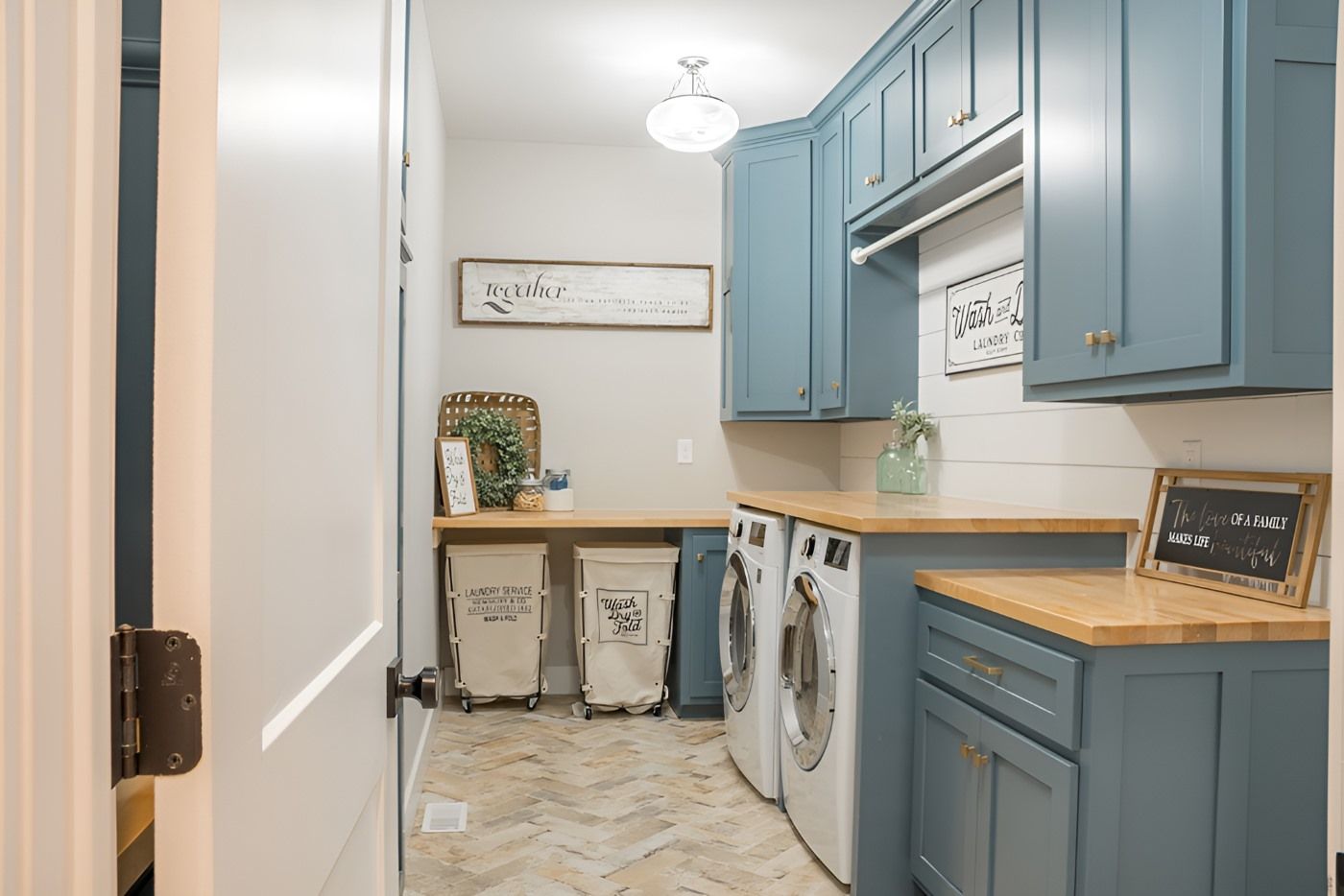 A Laundry Room With Blue Cabinets And White Appliances — O'Donnell Cabinetmaking in Kawana, QLD