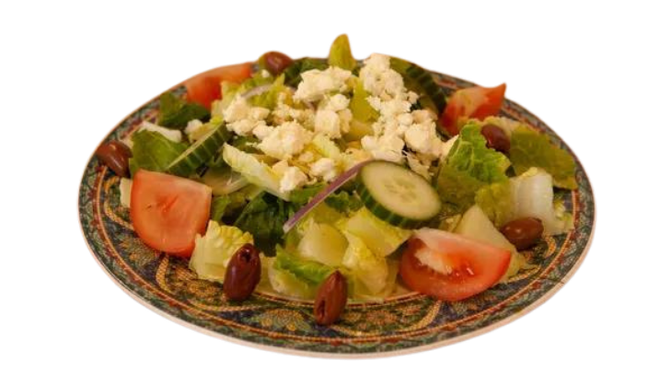 a salad with tomatoes , cucumbers , olives and feta cheese on a plate