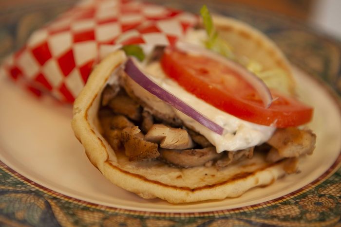 a close up of a gyro sandwich on a plate .