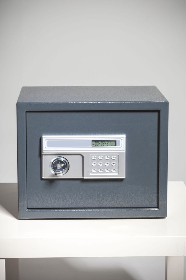 a digital safe is sitting on top of a white table .