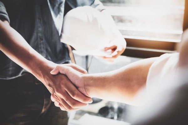contractor shaking hands with client