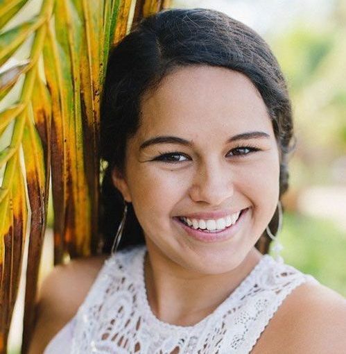 A woman smiling for the camera.
