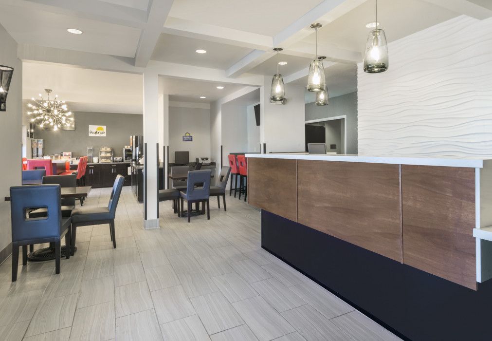 Hotel lobby with front desk, seating area, and breakfast bar.